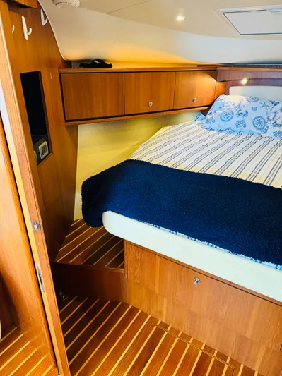 Why Knot Yacht Photos Pics 2007 Tiara Yachts 3900 Sovran cabin with bed and wooden cabinetry.