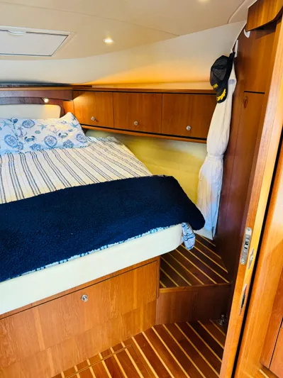 Why Knot Yacht Photos Pics 2007 Tiara Yachts 3900 Sovran cabin interior with bed and wooden cabinetry.