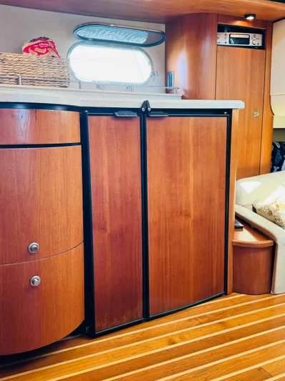 Why Knot Yacht Photos Pics 2007 Tiara Yachts 3900 Sovran interior with wooden cabinetry and flooring.