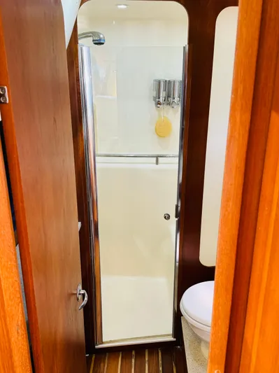 Why Knot Yacht Photos Pics 2007 Tiara Yachts 3900 Sovran bathroom with shower and wooden accents.