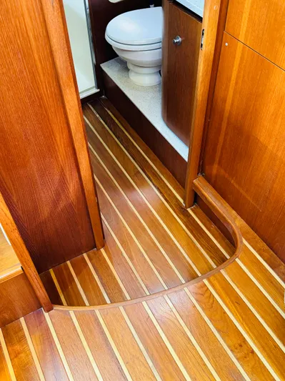 Why Knot Yacht Photos Pics 2007 Tiara Yachts 3900 Sovran interior with wooden flooring and bathroom view.