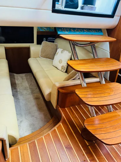Why Knot Yacht Photos Pics Interior of 2007 Tiara Yachts 3900 Sovran with wooden steps and beige seating.