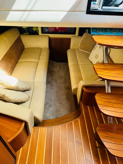 Why Knot Yacht Photos Pics 2007 Tiara Yachts 3900 Sovran interior with beige seating and wooden flooring.