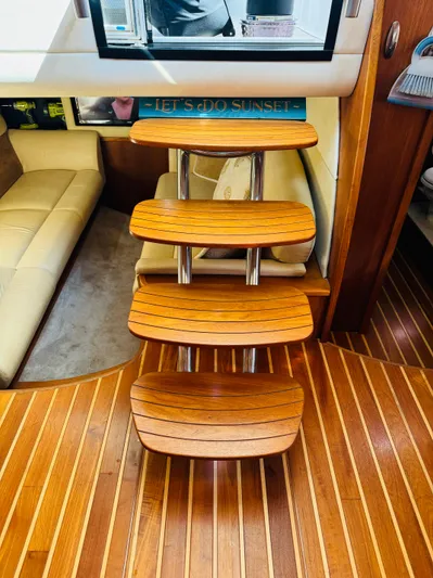 Why Knot Yacht Photos Pics Wooden steps inside a 2007 Tiara Yachts 3900 Sovran, leading to a cozy cabin.