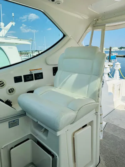 Why Knot Yacht Photos Pics Captain's chair on a 2007 Tiara Yachts 3900 Sovran, docked at a marina.