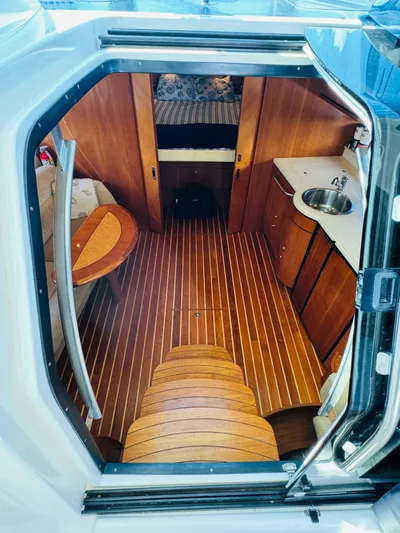 Why Knot Yacht Photos Pics 2007 Tiara Yachts 3900 Sovran interior cabin with wood flooring and kitchenette.