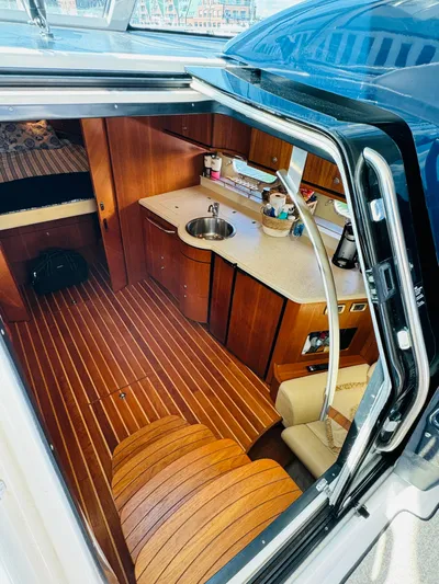Why Knot Yacht Photos Pics Interior of 2007 Tiara Yachts 3900 Sovran with wooden flooring and kitchenette.