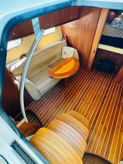 Why Knot Yacht Photos Pics Interior of 2007 Tiara Yachts 3900 Sovran with wooden flooring and cozy seating area.