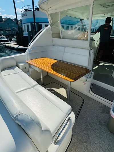 Why Knot Yacht Photos Pics 2007 Tiara Yachts 3900 Sovran with spacious outdoor seating and wooden table.