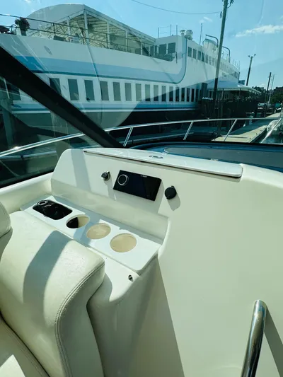 Why Knot Yacht Photos Pics 2007 Tiara Yachts 3900 Sovran helm station with cup holders and control panel.