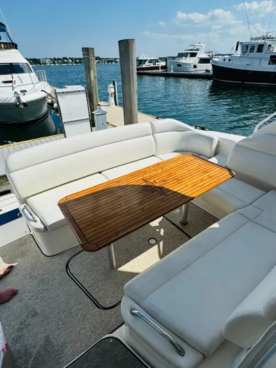 Why Knot Yacht Photos Pics 2007 Tiara Yachts 3900 Sovran with teak table and white seating at the dock.