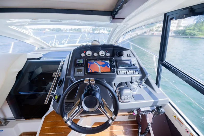 She Is Royal Yacht Photos Pics Cranchi M 44 HT 2014 yacht cockpit with navigation system and steering wheel.
