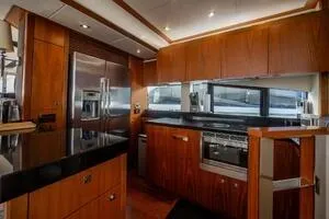  Yacht Photos Pics Luxurious kitchen interior of 2015 Sunseeker 75 yacht with modern appliances and wood cabinetry.