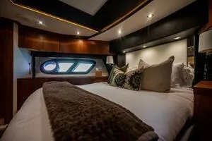  Yacht Photos Pics Luxurious bedroom interior of 2015 Sunseeker 75 yacht with elegant lighting and plush bedding.