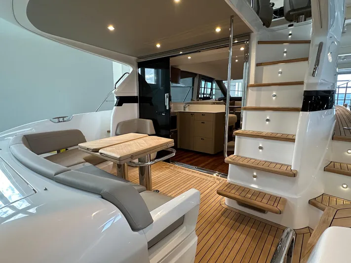 F45110 Yacht Photos Pics Luxurious 2024 Princess F45 yacht interior with elegant seating and wooden stairs.