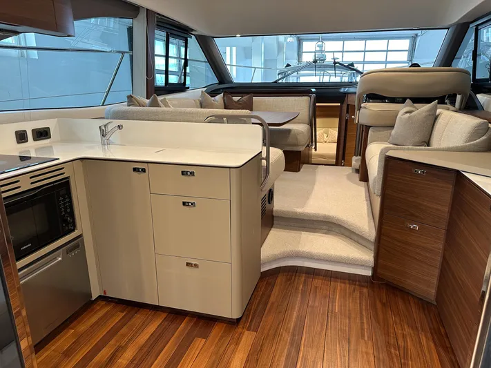 F45110 Yacht Photos Pics Luxurious interior of 2024 Princess F45 yacht with modern kitchen and seating area.