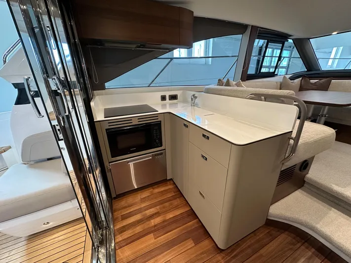 F45110 Yacht Photos Pics Modern kitchen area in 2024 Princess F45 yacht with sleek design and wood flooring.