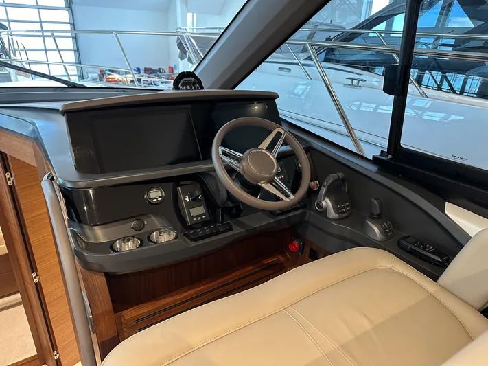 F45110 Yacht Photos Pics 2024 Princess F45 yacht helm with modern controls and leather seating.