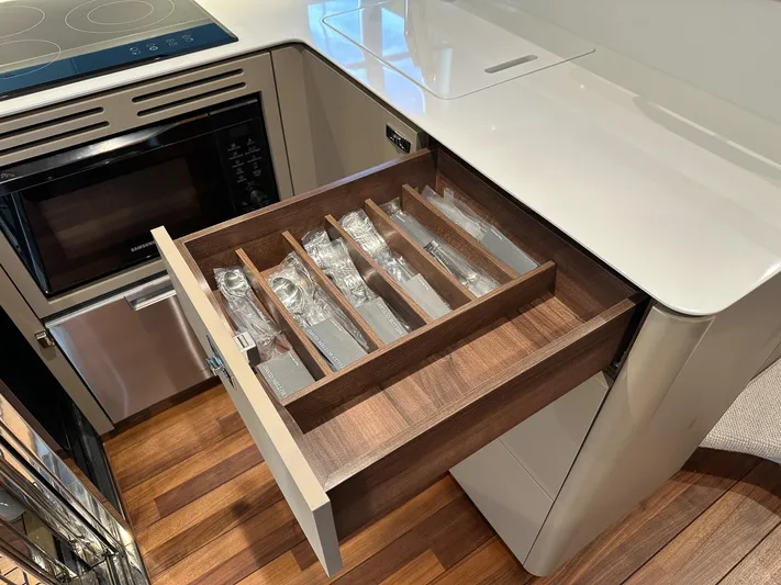 F45110 Yacht Photos Pics Modern kitchen drawer with organized cutlery in a 2024 Princess F45 yacht.
