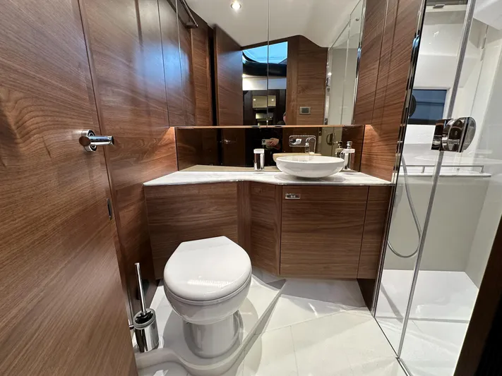 F45110 Yacht Photos Pics Luxurious bathroom in 2024 Princess F45 yacht with wood paneling and modern fixtures.