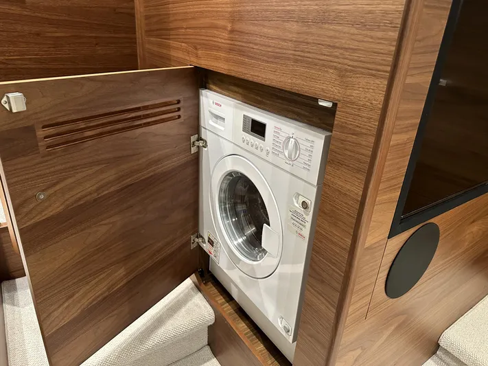 F45110 Yacht Photos Pics Built-in washing machine in 2024 Princess F45 yacht with wooden cabinetry.