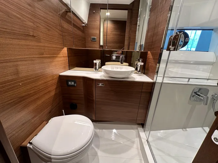 F45110 Yacht Photos Pics Luxurious bathroom in 2024 Princess F45 yacht with wood accents and modern fixtures.