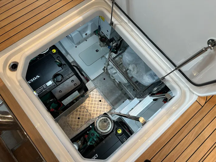 F45110 Yacht Photos Pics Engine compartment of 2024 Princess F45 yacht, showcasing mechanical components and wooden deck.