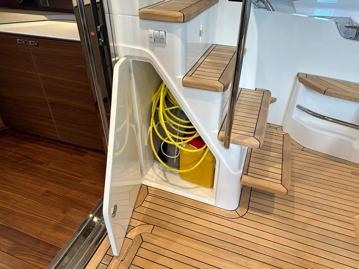 F45110 Yacht Photos Pics 2024 Princess F45 yacht interior with wooden flooring and storage compartment.