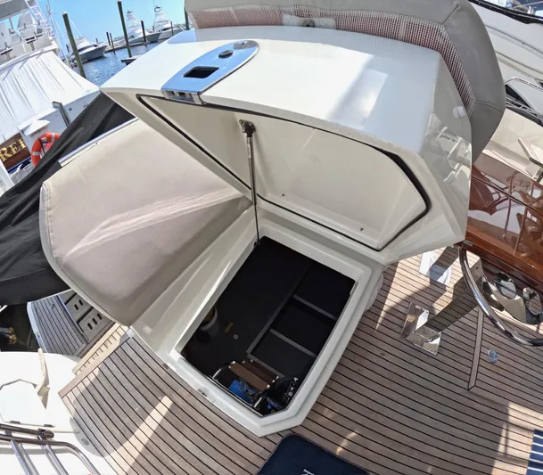  Yacht Photos Pics Open storage compartment on 2019 Prestige 520 yacht deck, showcasing spacious interior.