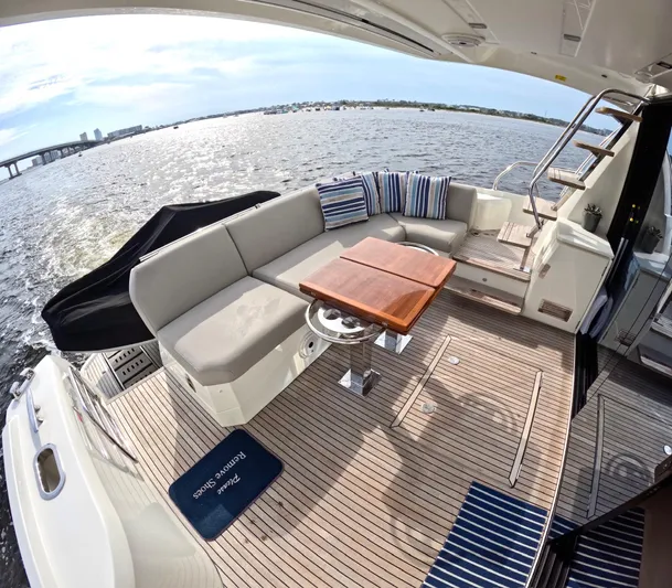  Yacht Photos Pics Luxurious 2019 Prestige 520 yacht deck with seating, table, and scenic water view.