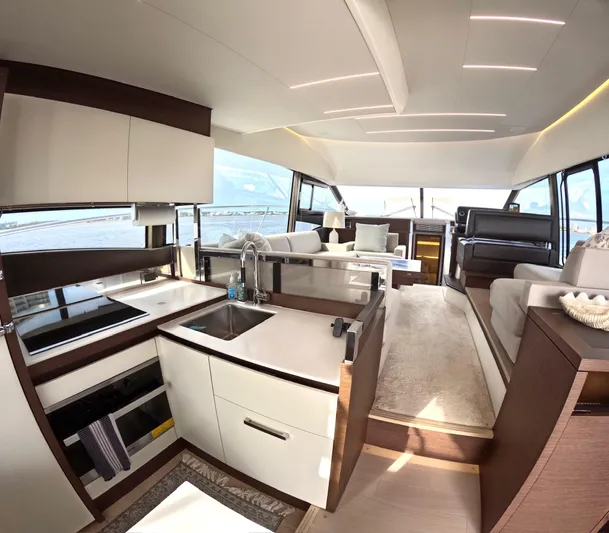 Yacht Photos Pics Luxurious interior of a 2019 Prestige 520 yacht with modern kitchen and seating area.