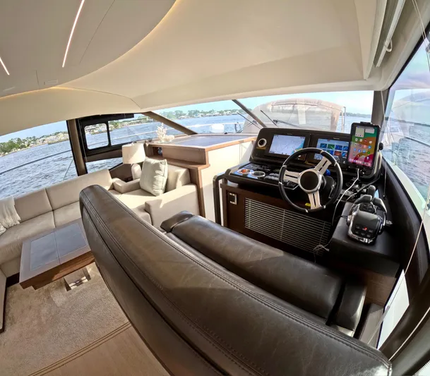  Yacht Photos Pics Luxurious interior of a 2019 Prestige 520 yacht with modern helm and seating area.