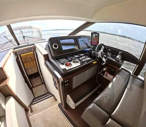  Yacht Photos Pics Interior of a 2019 Prestige 520 yacht cockpit with navigation controls and seating.