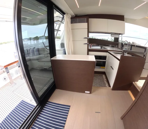  Yacht Photos Pics Modern kitchen interior on a 2019 Prestige 520 yacht, featuring sleek cabinetry and large windows.