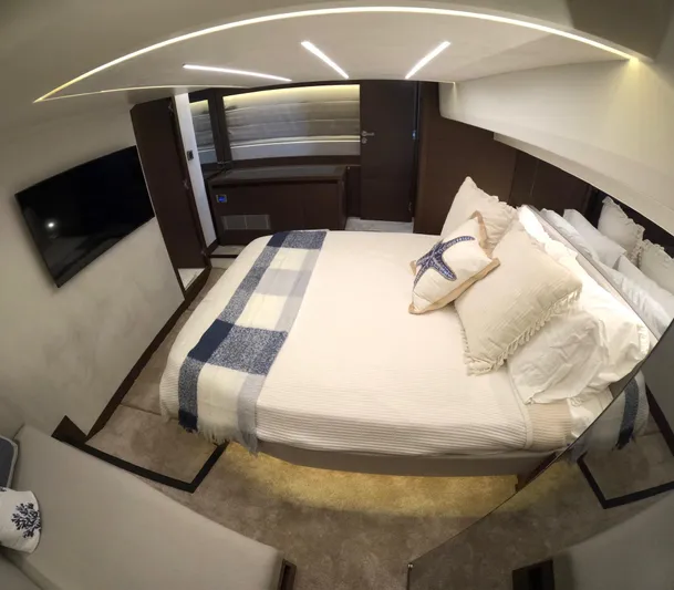  Yacht Photos Pics Luxurious bedroom interior of 2019 Prestige 520 yacht with modern decor and cozy bedding.