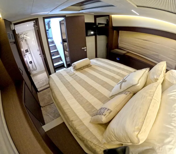  Yacht Photos Pics Luxurious bedroom interior of 2019 Prestige 520 yacht with striped bedding and elegant decor.