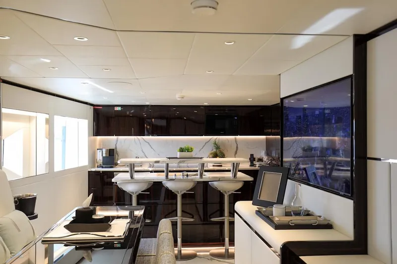  Yacht Photos Pics Luxurious interior of 2025 Majesty 120 yacht with modern bar and seating area.