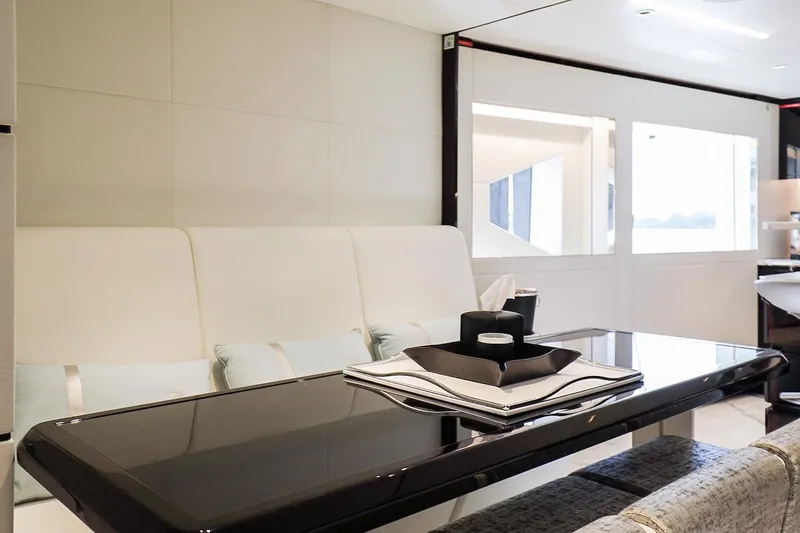  Yacht Photos Pics Luxurious interior of 2025 Majesty 120 yacht with sleek dining area and modern decor.