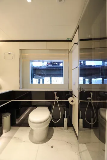  Yacht Photos Pics Luxurious bathroom in 2025 Majesty 120 yacht with modern fixtures and large window.