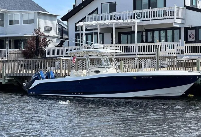  Yacht Photos Pics 2004 Hydra-Sports Vector 3300 CC boat docked by waterfront homes.