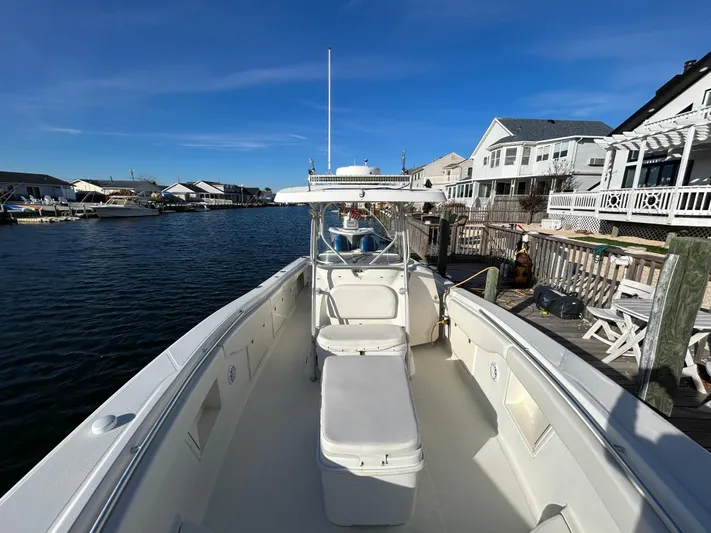  Yacht Photos Pics 2004 Hydra-Sports Vector 3300 CC docked by waterfront homes under clear blue sky.