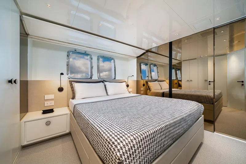 Clic - Sl96a/764 Yacht Photos Pics Luxurious bedroom interior on 2022 Sanlorenzo SL96A yacht with modern design and mirrored walls.