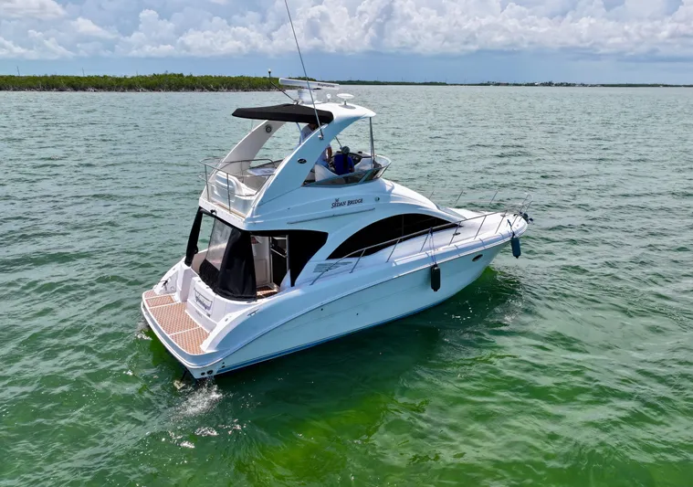  Yacht Photos Pics 2007 Sea Ray 36 Sedan Bridge yacht cruising on open water under a cloudy sky.