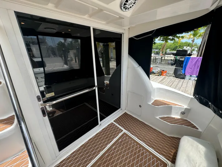  Yacht Photos Pics 2007 Sea Ray 36 Sedan Bridge yacht interior with sliding glass door and teak flooring.