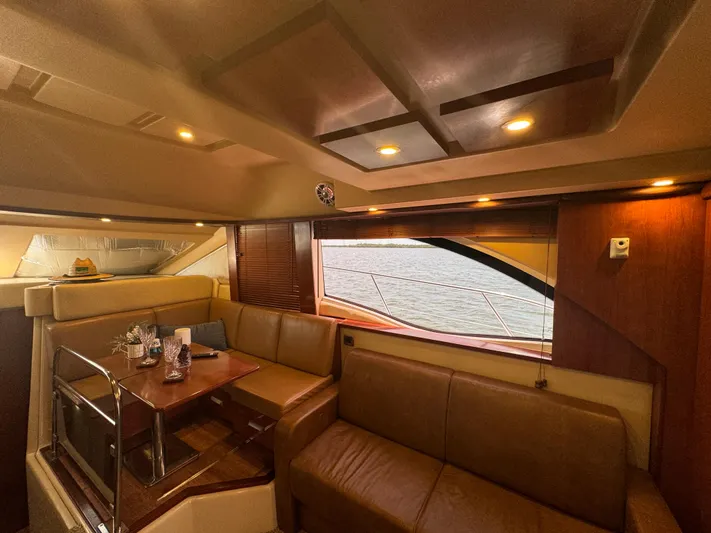  Yacht Photos Pics Luxurious interior of 2007 Sea Ray 36 Sedan Bridge yacht with leather seating and wooden accents.
