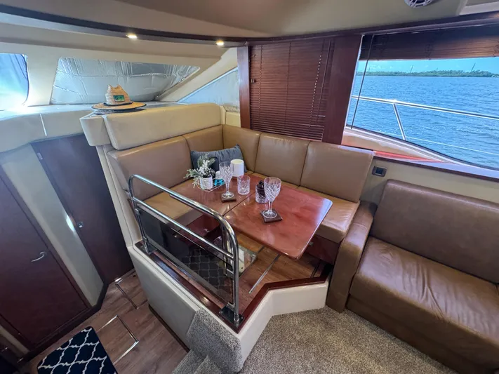  Yacht Photos Pics Luxurious interior of 2007 Sea Ray 36 Sedan Bridge with elegant dining area and scenic water view.