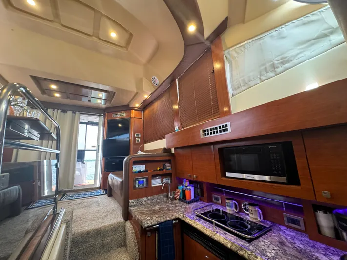  Yacht Photos Pics Luxurious interior of a 2007 Sea Ray 36 Sedan Bridge yacht with modern kitchen amenities.