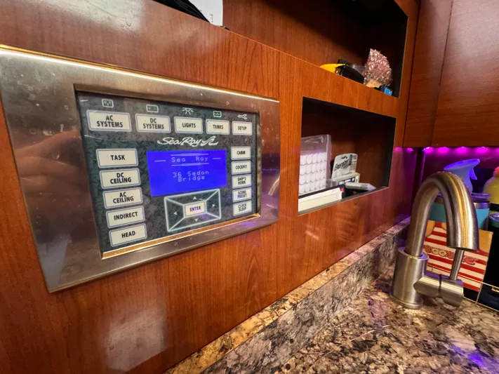 Yacht Photos Pics Control panel on 2007 Sea Ray 36 Sedan Bridge yacht interior, with wood finish and faucet.
