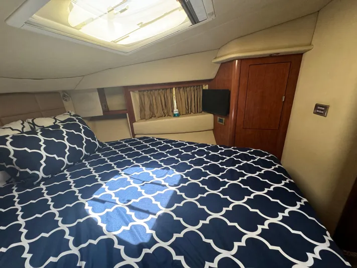  Yacht Photos Pics 2007 Sea Ray 36 Sedan Bridge cabin with patterned bedding and wooden cabinetry.