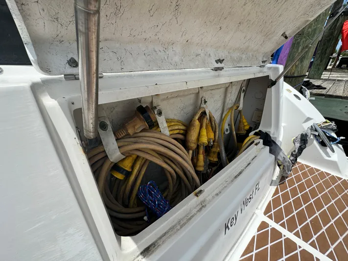  Yacht Photos Pics Storage compartment on a 2007 Sea Ray 36 Sedan Bridge, containing coiled cables.